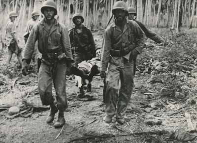 Four US Marines carry an injured compatriot